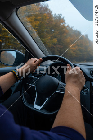 Person Driving by the road at foggy autumn highway 117574726
