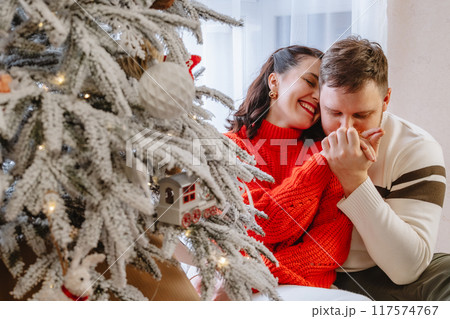 beautiful couple near christmas tree beautiful couple near christmas tree 117574767