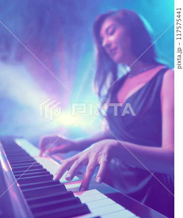 Festival of instrumental music. Photo with focus on elegant, flexible fingers of woman, performing piano solo. Festival of instrumental music. Photo with focus on elegant, flexible fingers of woman, performing piano solo. 117575441