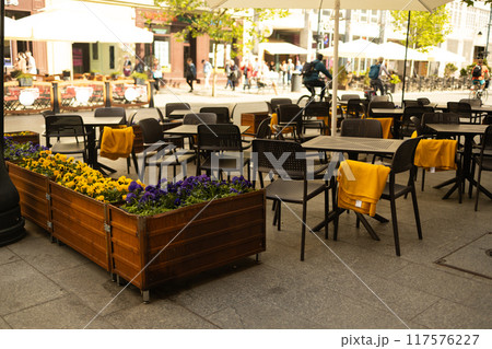 Cozy street with tables of cafe in Krakow, Poland. Architecture and landmark. Cozy cityscape 117576227