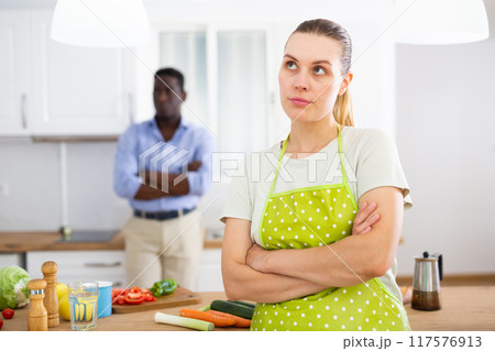 Young woman offended after quarrel with husband in home kitchen Young woman offended after quarrel with husband in home kitchen 117576913