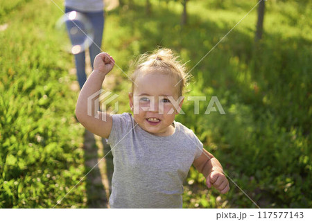 teen sister blowing soap bubbles for toddler 117577143