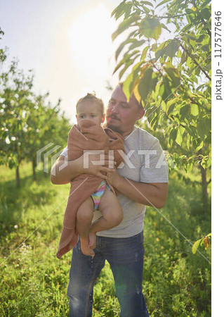 a dad wraps, hugs and kisses his toddler after a bath a dad wraps, hugs and kisses his toddler after a bath 117577646