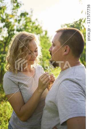 the wife weaves flowers into her husband's beard 117577736