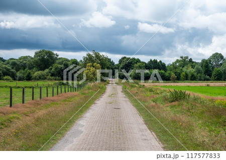 Cycling trail through the fields of the German countryside around Bredenau, Lower Saxony, Germany Cycling trail through the fields of the German countryside around Bredenau, Lower Saxony, Germany 117577833