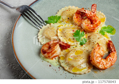 ravioli with shrimp, in cream sauce, with spices and herbs, top view, no people, 117578043