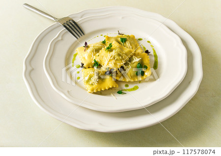 Ravioli with spinach and cheese, green sauce, on a light background, selective focus, no people, 117578074