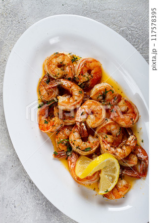 fried tiger prawns, jumbo, in garlic sauce, in butter, with herbs, on a white plate, homemade, no people, 117578395