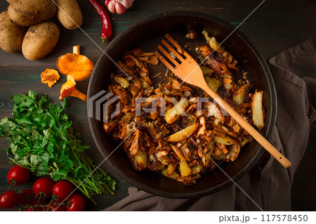 Fried chanterelles with mushrooms, in a clay pan, close-up, top view, selective focus, 117578450