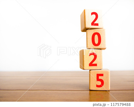 Business concept of 2025 new year symbol. Beautiful turned wooden cube and changed number 2024 to 2025. Beautiful wooden table white background, copy space. Business 2025 happy new year concept. Business concept of 2025 new year symbol. Beautiful turned wooden cube and changed number 2024 to 2025. Beautiful wooden table white background, copy space. Business 2025 happy new year concept. 117579488