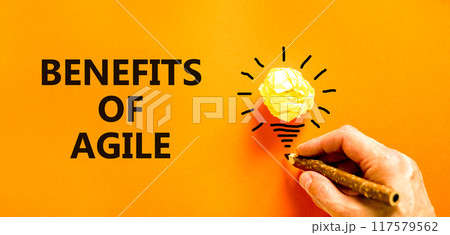 Benefits of agile symbol. Concept words Benefits of agile on beautiful orange paper. Beautiful orange background. Light bulb icon. Businessman hand. Business benefits of agile concept. Copy space. Benefits of agile symbol. Concept words Benefits of agile on beautiful orange paper. Beautiful orange background. Light bulb icon. Businessman hand. Business benefits of agile concept. Copy space. 117579562