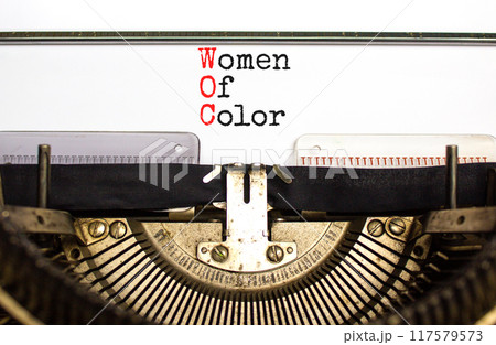 WOC women of color symbol. Concept words WOC women of color typed on beautiful old retro typewriter. Beautiful white background. Business WOC women of color social issues concept. Copy space. 117579573