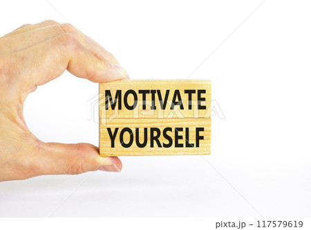 Motivate yourself symbol. Concept words Motivate yourself on beautiful wooden blocks. Beautiful white background. Businessman hand. Business psychology motivate yourself concept. Copy space. 117579619