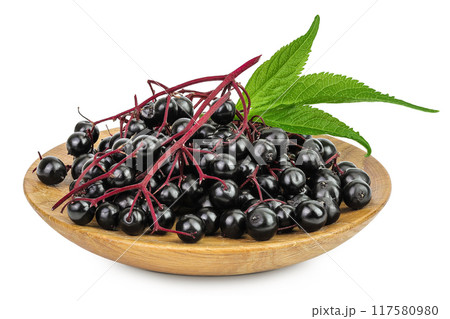 Ripe black elderberry or elder with green leaves in wooden bowl isolated on a white background. Sambucus Ripe black elderberry or elder with green leaves in wooden bowl isolated on a white background. Sambucus 117580980