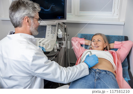 Female mature woman having an ultrasonography procedure 117581210