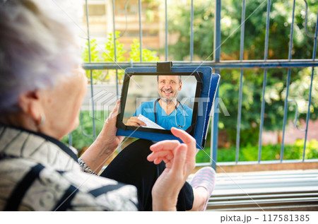 Gray Hair Meets Digital Care: Elderly Patient's Outdoor Telemedicine Session Highlights the Future of Geriatric Health Management. 117581385