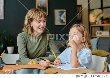 Young beautiful Caucasian mom smiling and waiting for her daughter who thinking about sketch idea 117581673