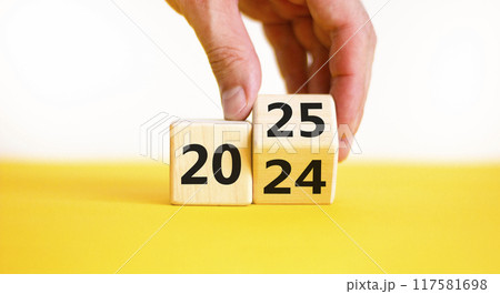 Business concept of 2025 new year symbol. Businessman turns wooden cube and changes number 2024 to 2025. Beautiful yellow table white background, copy space. Business 2025 happy new year concept. Business concept of 2025 new year symbol. Businessman turns wooden cube and changes number 2024 to 2025. Beautiful yellow table white background, copy space. Business 2025 happy new year concept. 117581698
