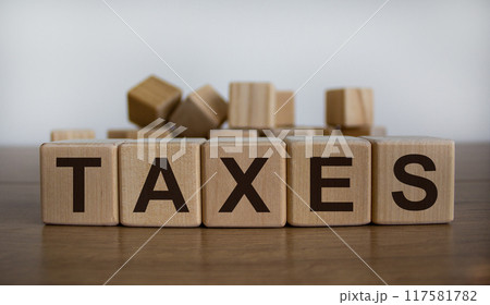 Concept word 'taxes' on cubes on a beautiful wooden table. White background. Business concept. 117581782