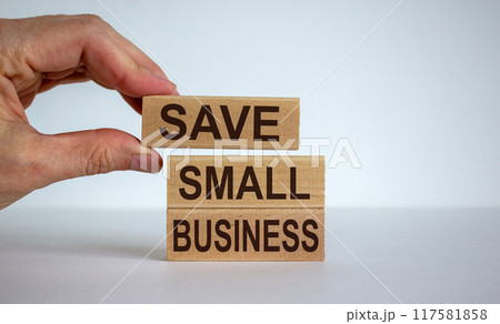Male hand placing a blocks with word 'save' on top of a blocks tower with words 'small business'. Beautiful white background. 117581858