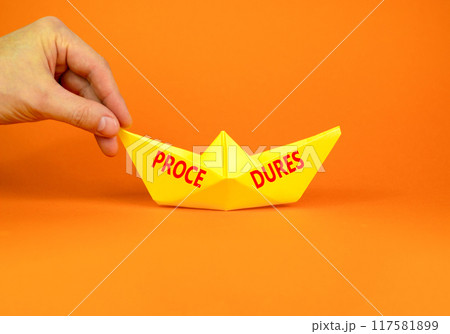 Procedures symbol. Concept word Procedures on beautiful yellow paper boat. Beautiful orange background. Businessman hand. Business procedures concept. Copy space. 117581899