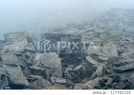 ruins of a mountain hut among rocks in the highlands in thick fog ruins of a mountain hut among rocks in the highlands in thick fog 117582128