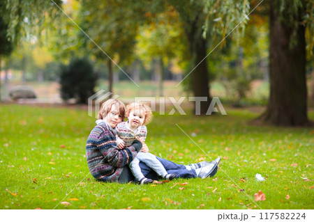 Kids play in autumn park Kids play in autumn park 117582224