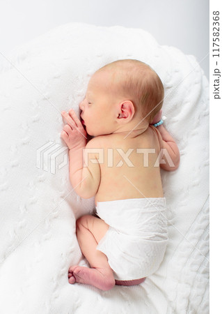 Newborn baby boy in hospital cot Newborn baby boy in hospital cot 117582368