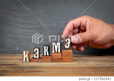KARMA. Wooden letters, alphabet blocks on steps. development and growth concept 117582941