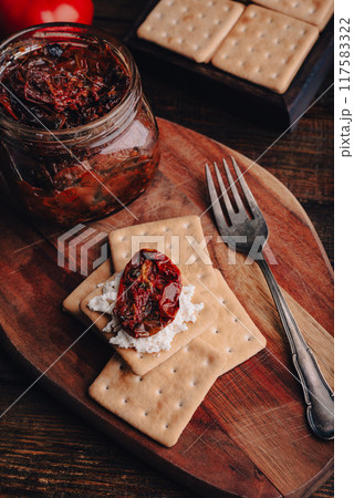 Crispy crackers with cottage cheese and sun-dried tomatoes Crispy crackers with cottage cheese and sun-dried tomatoes 117583322