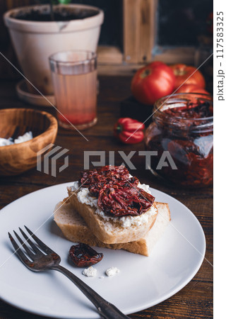White bread with sun-dried tomatoes and cream cheese White bread with sun-dried tomatoes and cream cheese 117583325