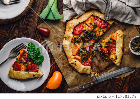 Sliced tomato galette on baking paper 117583378