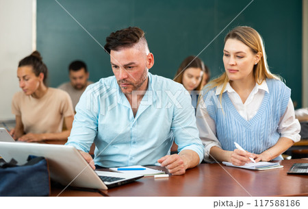 Concentrated students studying in the university auditorium 117588186
