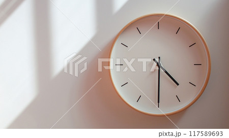 Minimalist Wooden Clock at 16.30/04.30 with Soft Shadows on White Wall - Perfect for Time Management and Lifestyle Branding 117589693