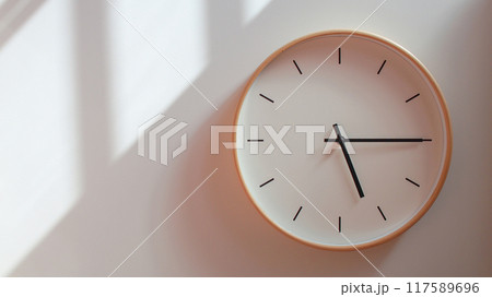 Minimalist Wooden Clock at 17.15/05.15 with Soft Shadows on White Wall - Perfect for Time Management and Lifestyle Branding Minimalist Wooden Clock at 17.15/05.15 with Soft Shadows on White Wall - Perfect for Time Management and Lifestyle Branding 117589696