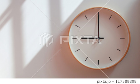 Minimalist Wooden Clock at 21.00/09.00 with Soft Shadows on White Wall - Perfect for Time Management and Lifestyle Branding 117589809