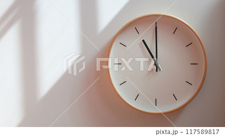 Minimalist Wooden Clock at 23.00/11.00 with Soft Shadows on White Wall - Perfect for Time Management and Lifestyle Branding 117589817