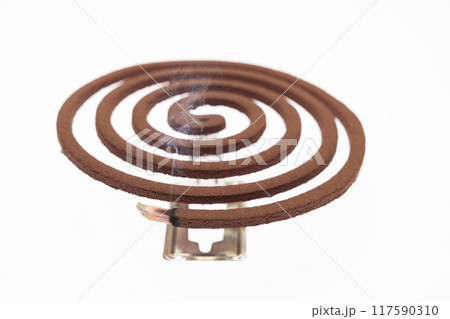 A mosquito coil with smoke coming out of it 117590310