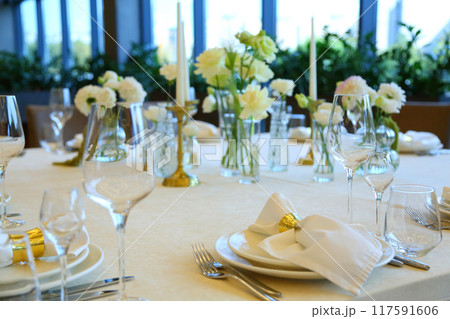 Table setting in a restaurant. Empty glasses set in restaurant. Table setting with glasses, cutlery and plates. Restaurant interior. Table setting in a restaurant. Empty glasses set in restaurant. Table setting with glasses, cutlery and plates. Restaurant interior. 117591606