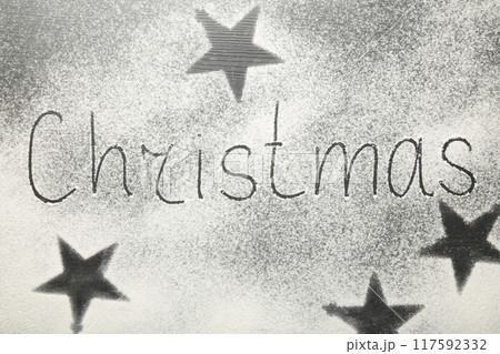 Christmas composition. Christmas text made with flour on black background. Christmas composition. Christmas text made with flour on black background. 117592332