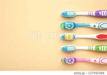 Toothbrushes on beige background with copy space. Toothbrushes on beige background with copy space. 117592366