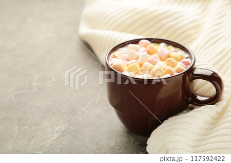 Hot chocolate with a marshmallows on grey concrete background. Hot chocolate with a marshmallows on grey concrete background. 117592422