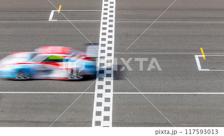 Motion blur race car racing on speed track, Car race on the international circuit race track crossing start and finish line, Race car crossing start and finish line, Target business achieve. 117593013