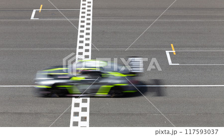 Motion blur race car racing on speed track, Car race on the international circuit race track crossing start and finish line, Race car crossing start and finish line, Target business achieve. 117593037