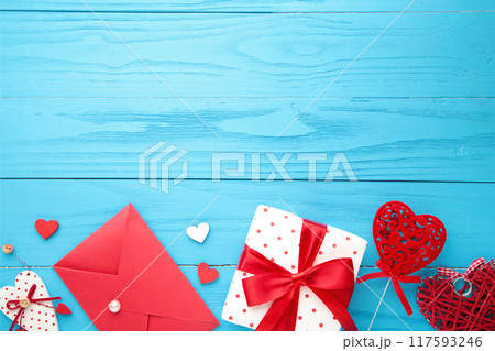 Valentine's day card. Composition with gifts, red hearts and rose on blue. Valentine's day card. Composition with gifts, red hearts and rose on blue. 117593246