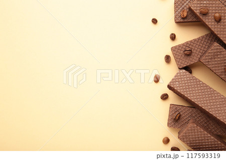 Chocolate wafers with coffee on beige background 117593319