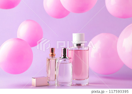 Perfume bottles with pink baloons on pink Perfume bottles with pink baloons on pink 117593395
