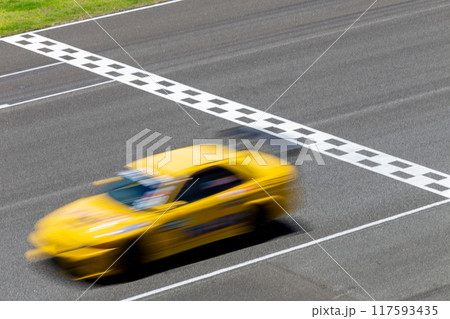 Motion blur race car racing on speed track, Car race on the international circuit race track crossing start and finish line, Race car crossing start and finish line, Target business achieve victory. 117593435