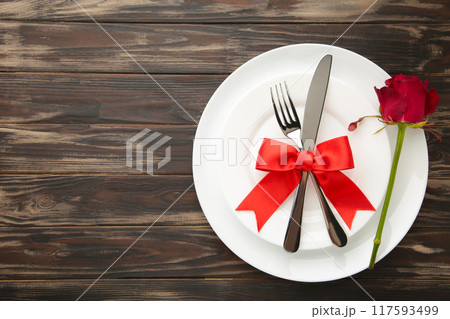 Festive table setting for Valentines Day on brown background 117593499