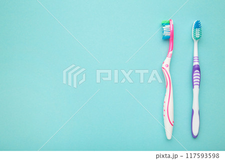 Two toothbrushes on blue background with copy space. Two toothbrushes on blue background with copy space. 117593598